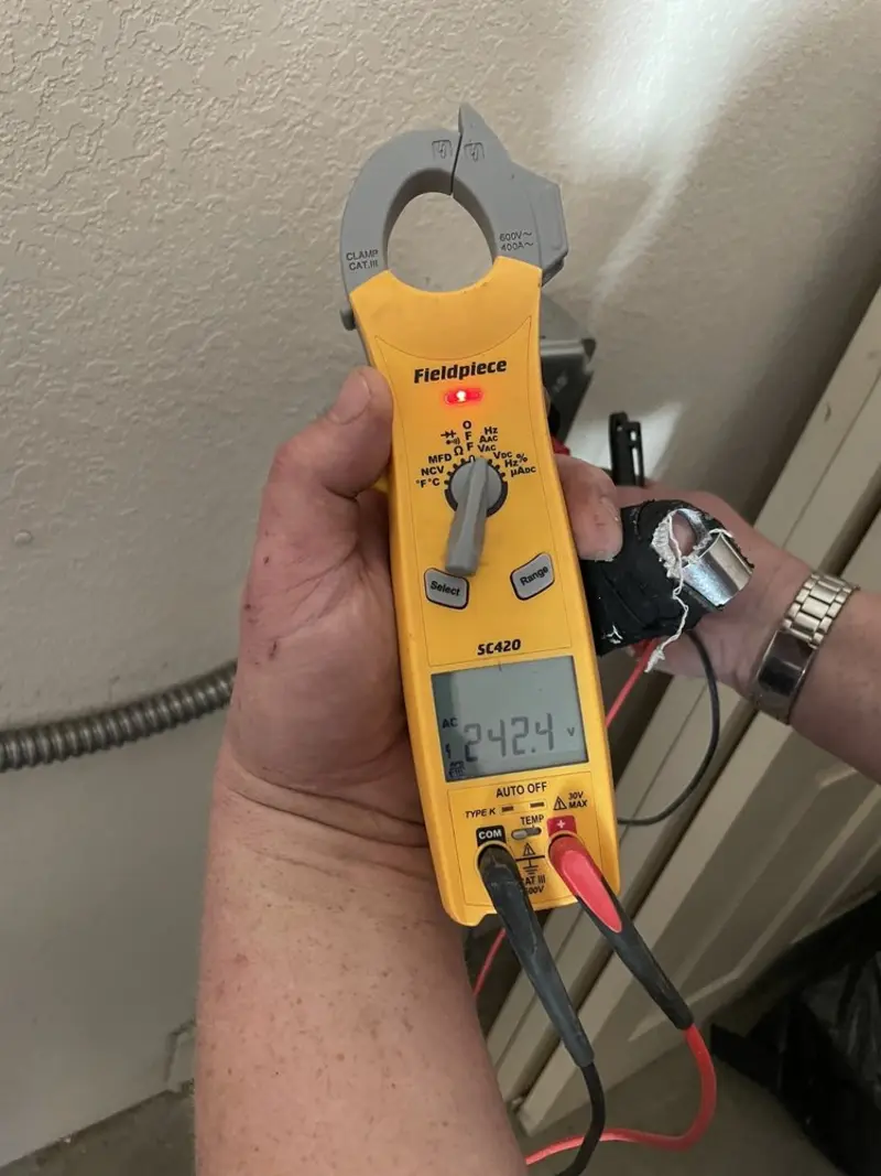 Voltage testing with clamp meter during Electrical Installation Services in Le Claire